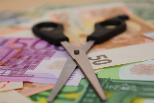 scissors on top of money