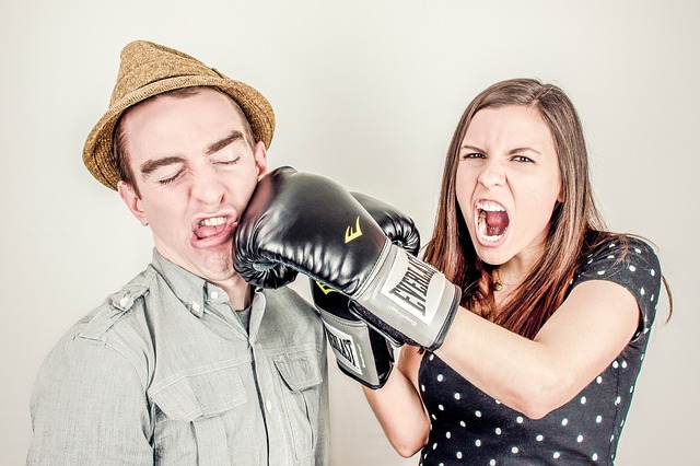 woman punching man with boxing glove